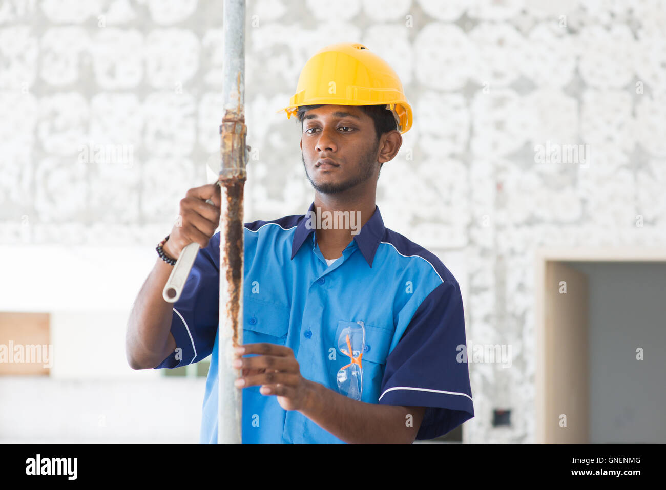 indian male plumber on site using hammer Stock Photo Alamy