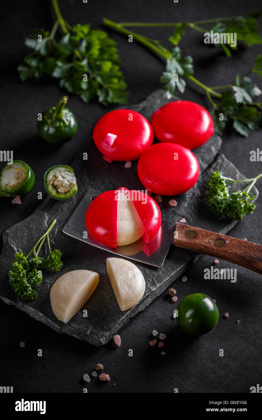Wheel of soft cheese covered with red wax Stock Photo - Alamy