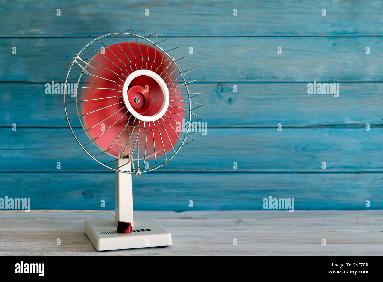 electric fan 70 on blue wooden background. Copy space Stock Photo