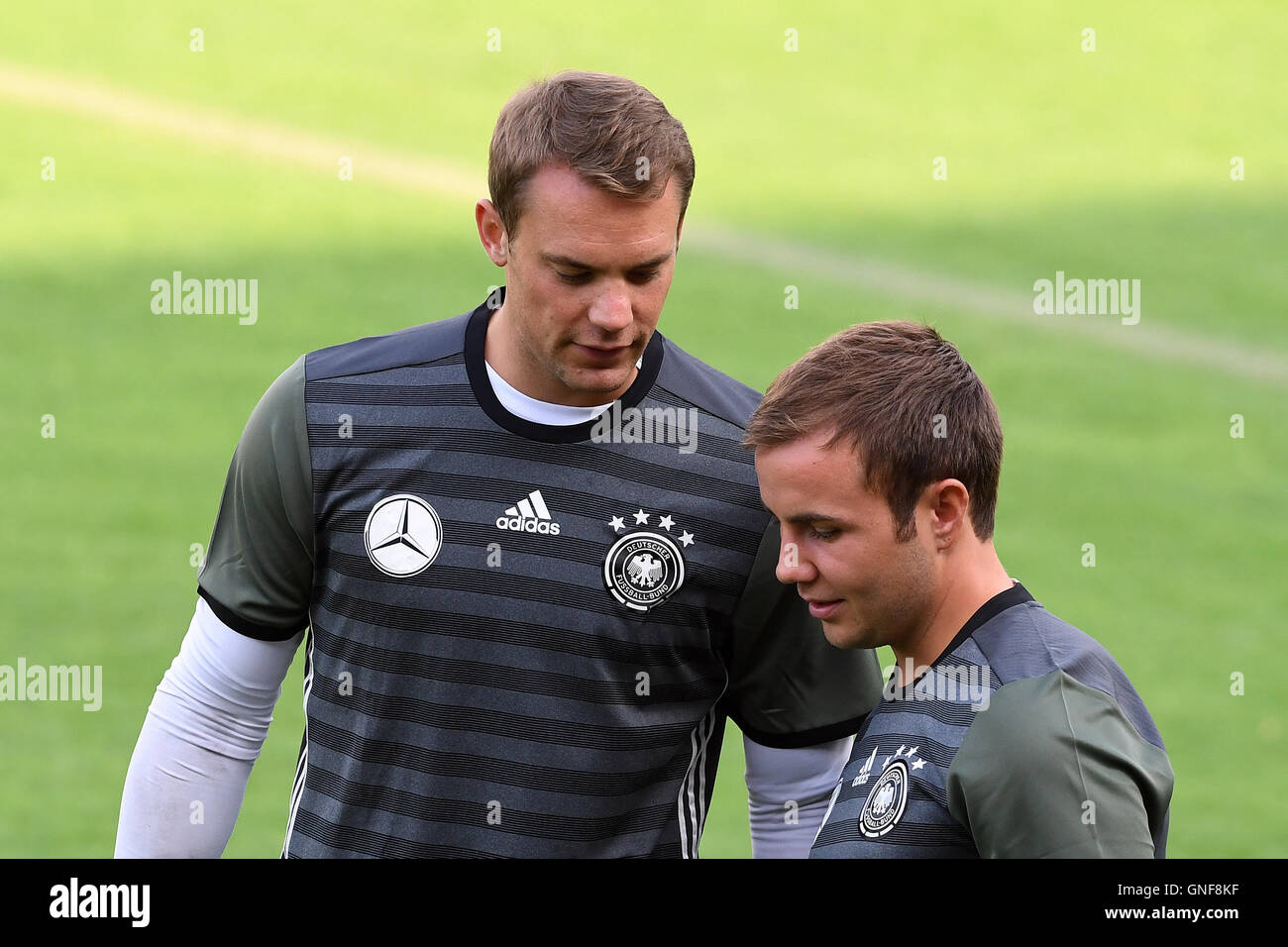 National team players Manuel Neuer (l) and Mario Goetze talk