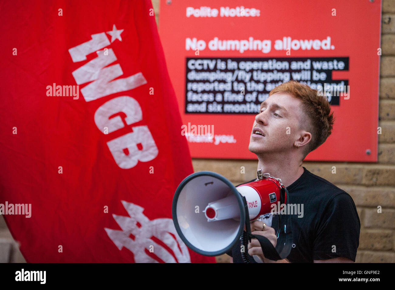 London, UK. 30th Aug, 2016.  Ben Geraghty, Deliveroo courier, protests with fellow IWGB members outside the headquarters of UberEats, Uber's fast-food delivery service, to call for the reinstatement of Imran Siddiqui, the organiser of an earlier protest against a pay cut for the company's couriers, and for a living wage for the company's couriers. Credit:  Mark Kerrison/Alamy Live News Stock Photo