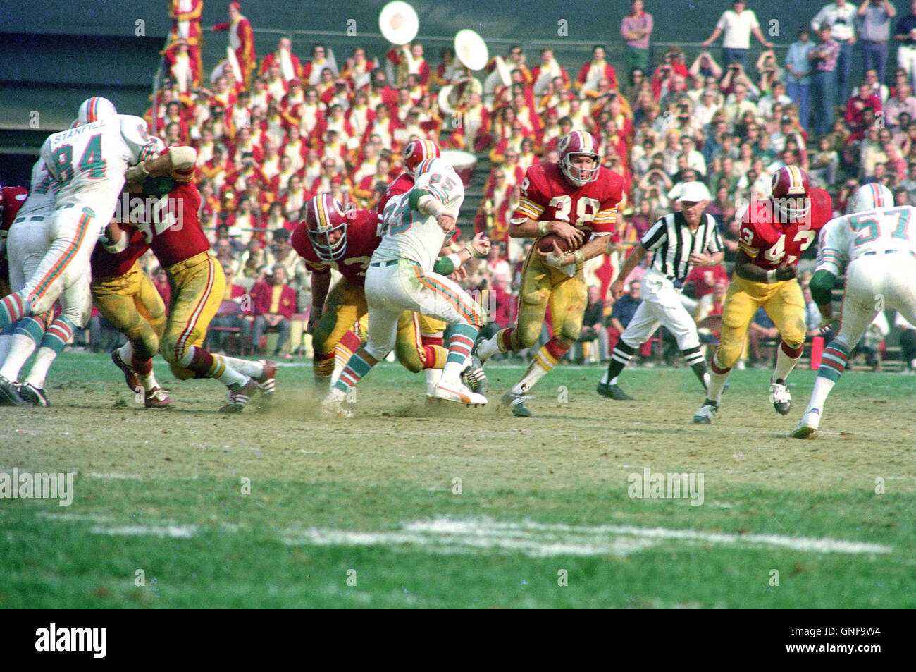 Washington Redskins running back Larry Smith (38) carries the ball during  the game against the Miami Dolphins at RFK Stadium in Washington, DC on  October 13, 1974. Pictured from left to right