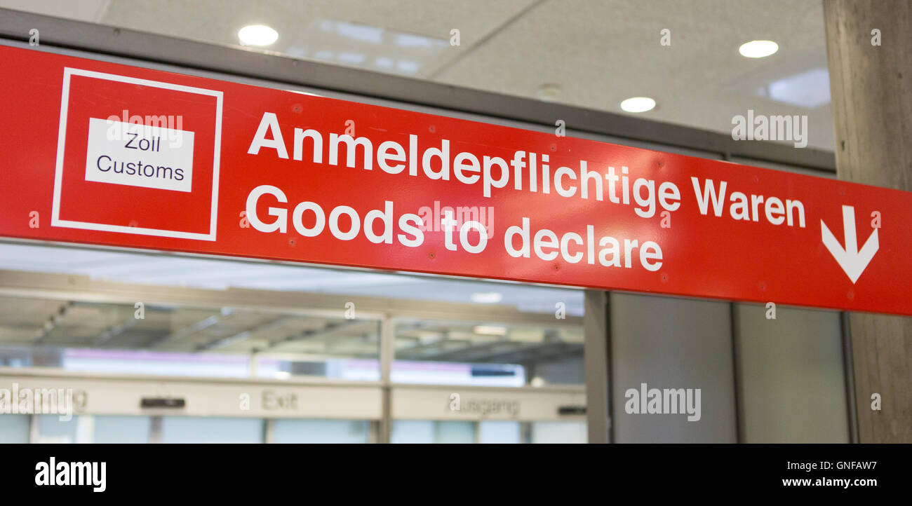 A sign written with 'Zoll Customs, Anmeldepflichtige Waren, Goods to declare' hangs at the airport in Stuttgart, Germany, 30 August 2016. Photo: Silas Stein/dpa Stock Photo