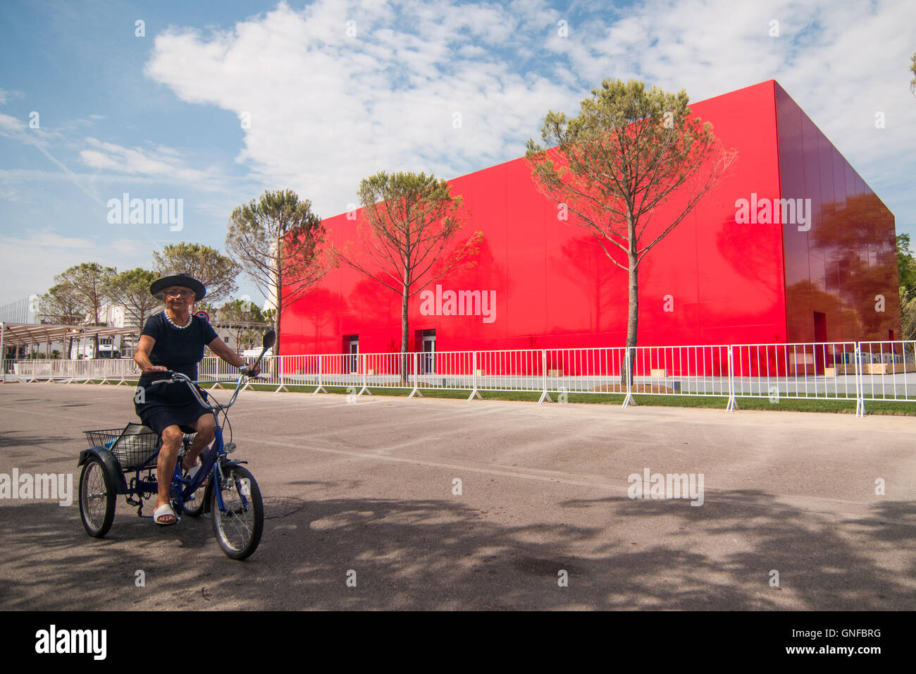 Venice, Italy. 30th August, 2016. A visitor passes in front of one of the palaces of the 73rd Venice Film Festival. Credit:  Simone Padovani / Awakening / Alamy Live News Stock Photo