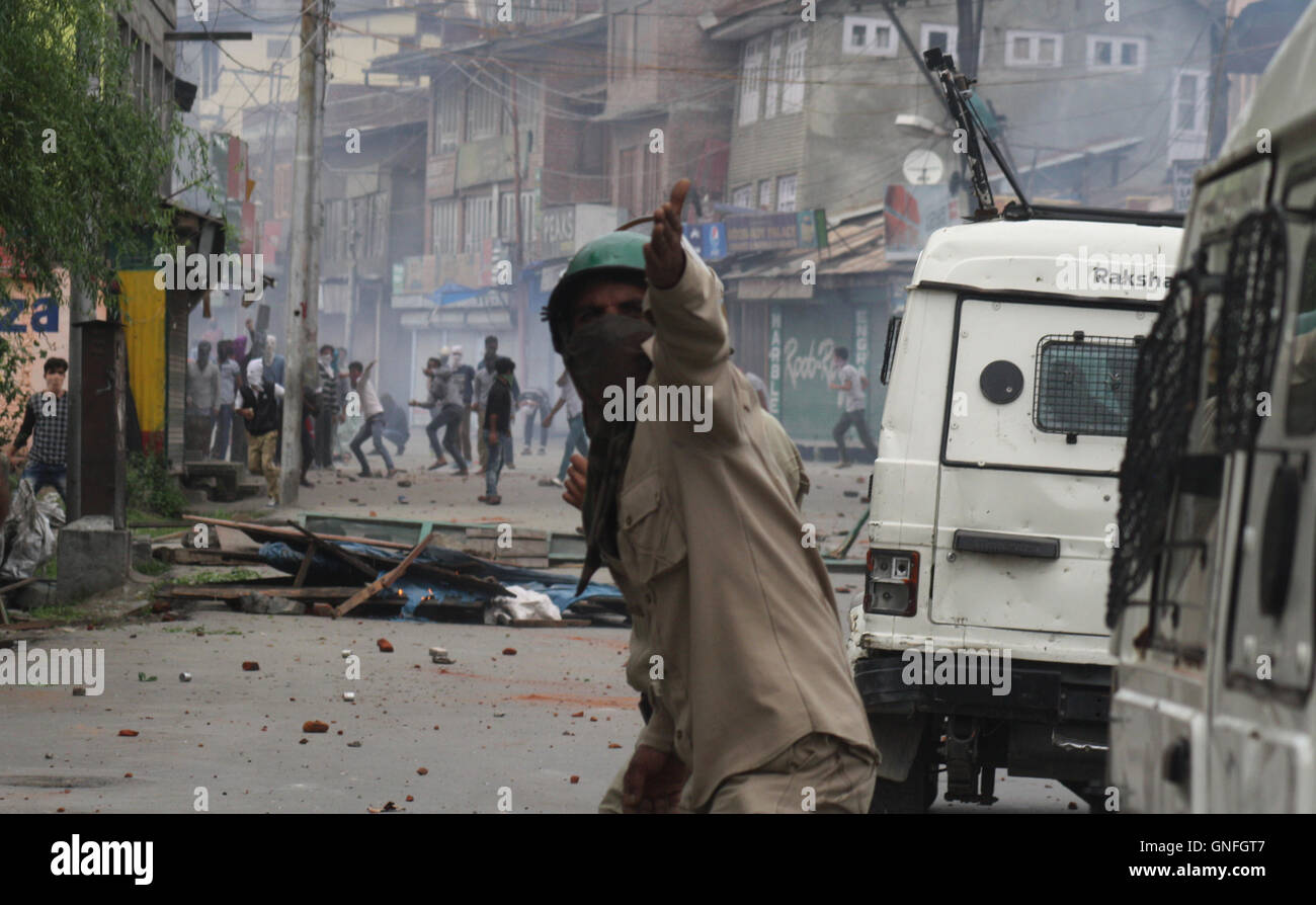 Srinagar, Indian Administered Kashmir. 31st August, 2016. An Indian policemen calling colleagues for help after protesters out of control , during a protest in old city Srinagar .One civilian was killed and four others injured in Army firing .Authorities lifted curfew from all areas of Kashmir after 54 days.due to separatists-sponsored strike call. Credit:  sofi suhail/Alamy Live News Stock Photo