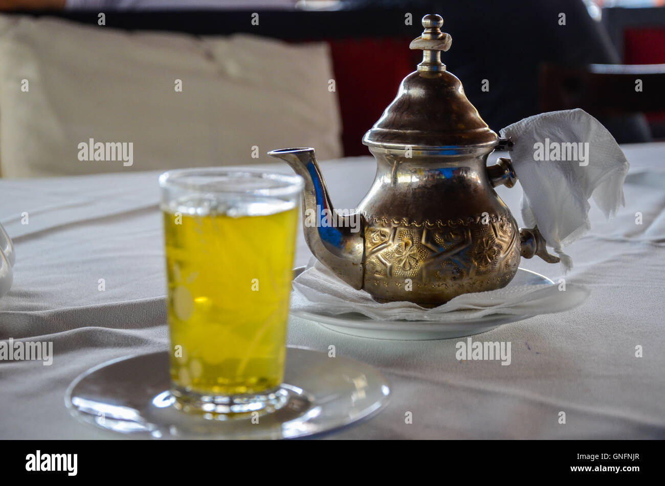 Traditional Moroccan mint tea served from authentic copper teapot. Selective focus Stock Photo