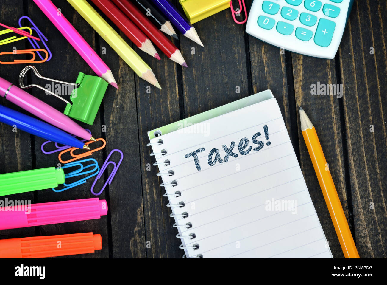 Taxes text on notepad and office tools on wooden table Stock Photo Alamy