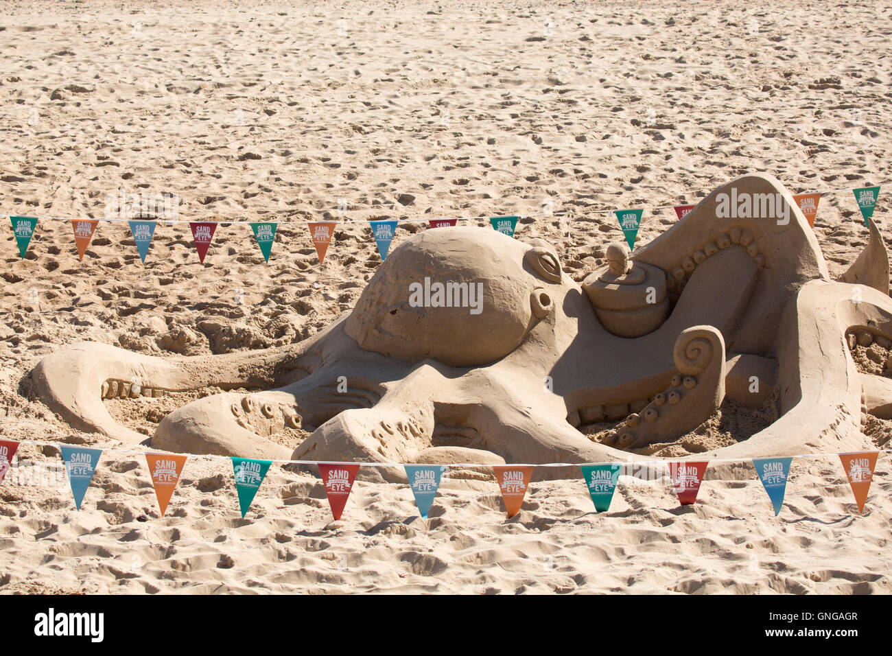A giant octopus sand sculpture during the Sand In Your Eye event at Blyth Beach in Northumberland, England. Stock Photo