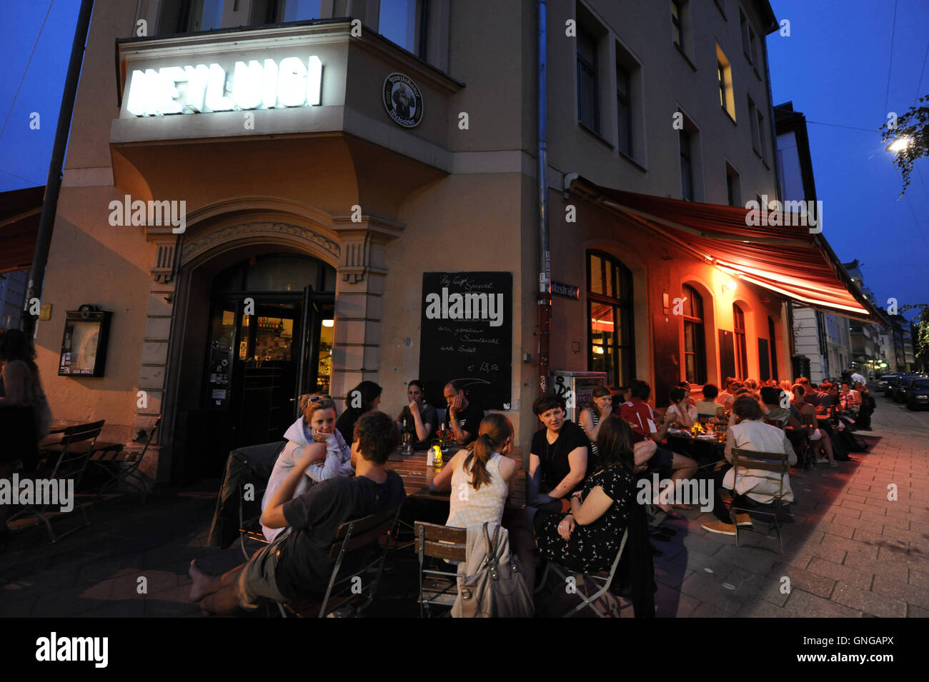 'Guests sit in front of the restaurant ''Hey Luigi'' in Munich, 2014' Stock Photo