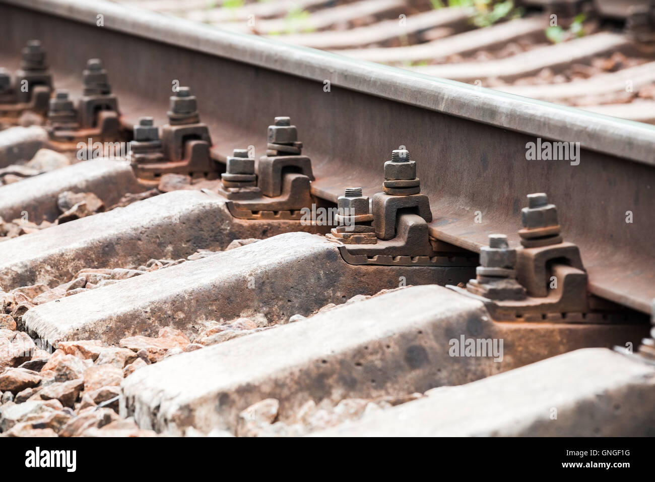Modern railway track details, closeup photo with selective focus Stock Photo