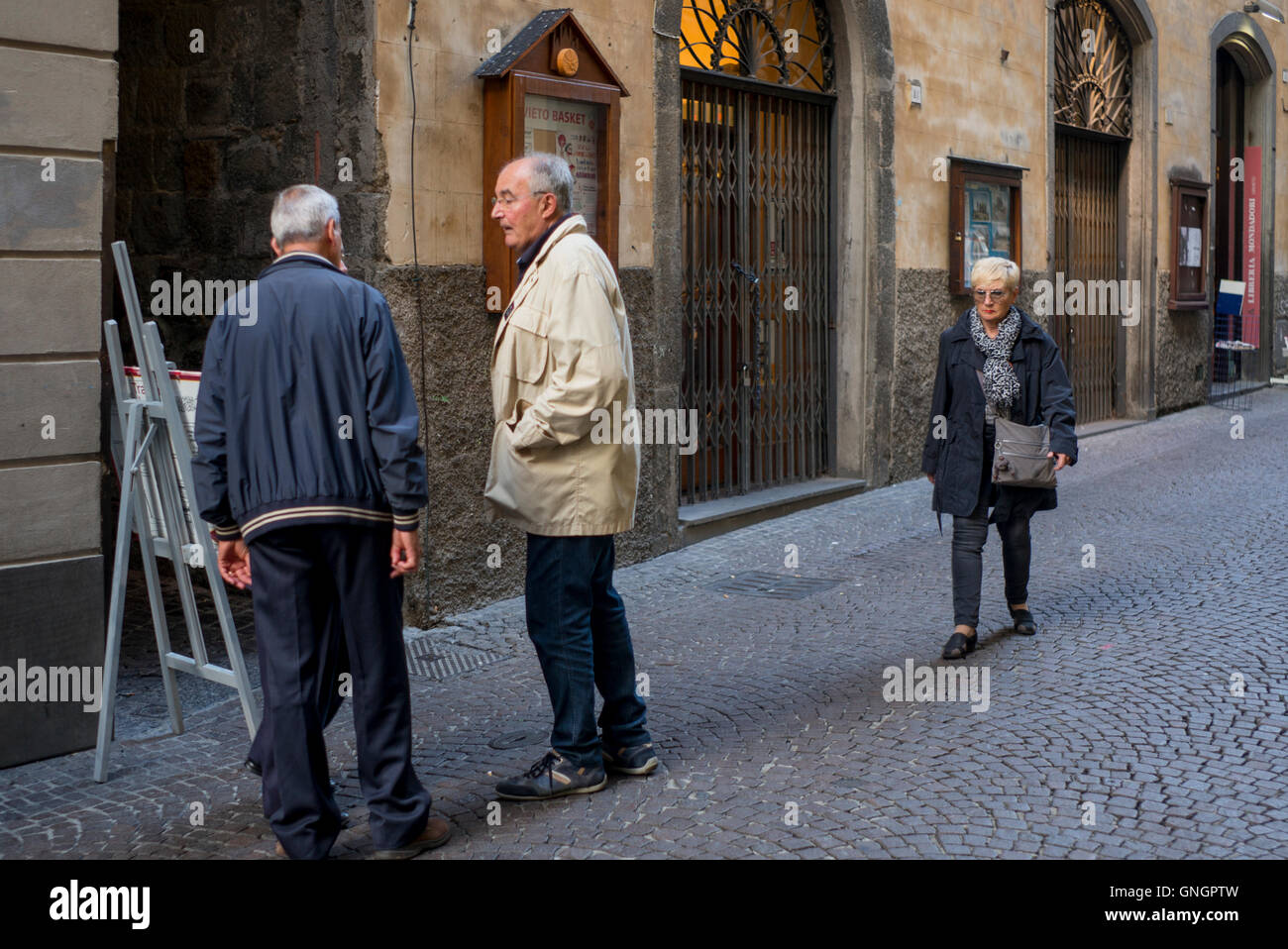 Senior people talking on street, Orvieto, Terni Province, Umbria, Italy Stock Photo