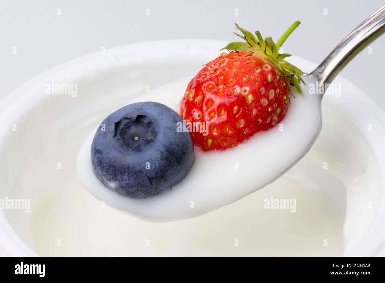 close-up of white yogurt with blueberries and strawberries Stock Photo