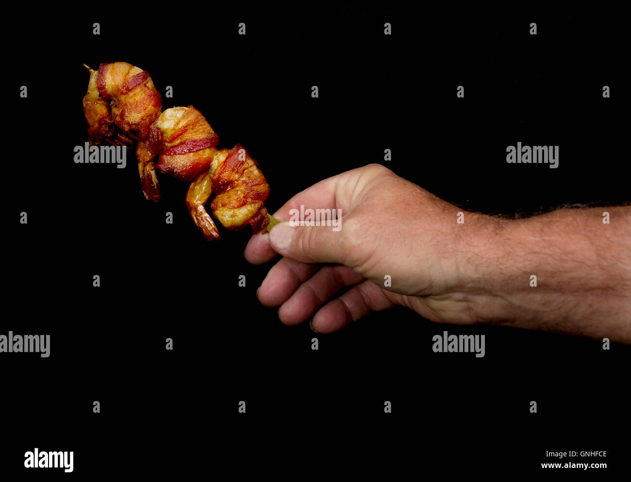 Shrimp Wrapped in Bacon on a stick is seen at the Minnesota State Fair in St. Paul, MN, August  27, 2016 Stock Photo