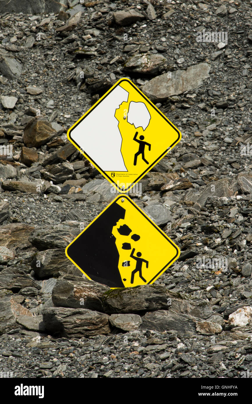 Glacial risks at Franz Josef Glacier in the Southern Alps of New Zealand are announced by warning signs. Stock Photo