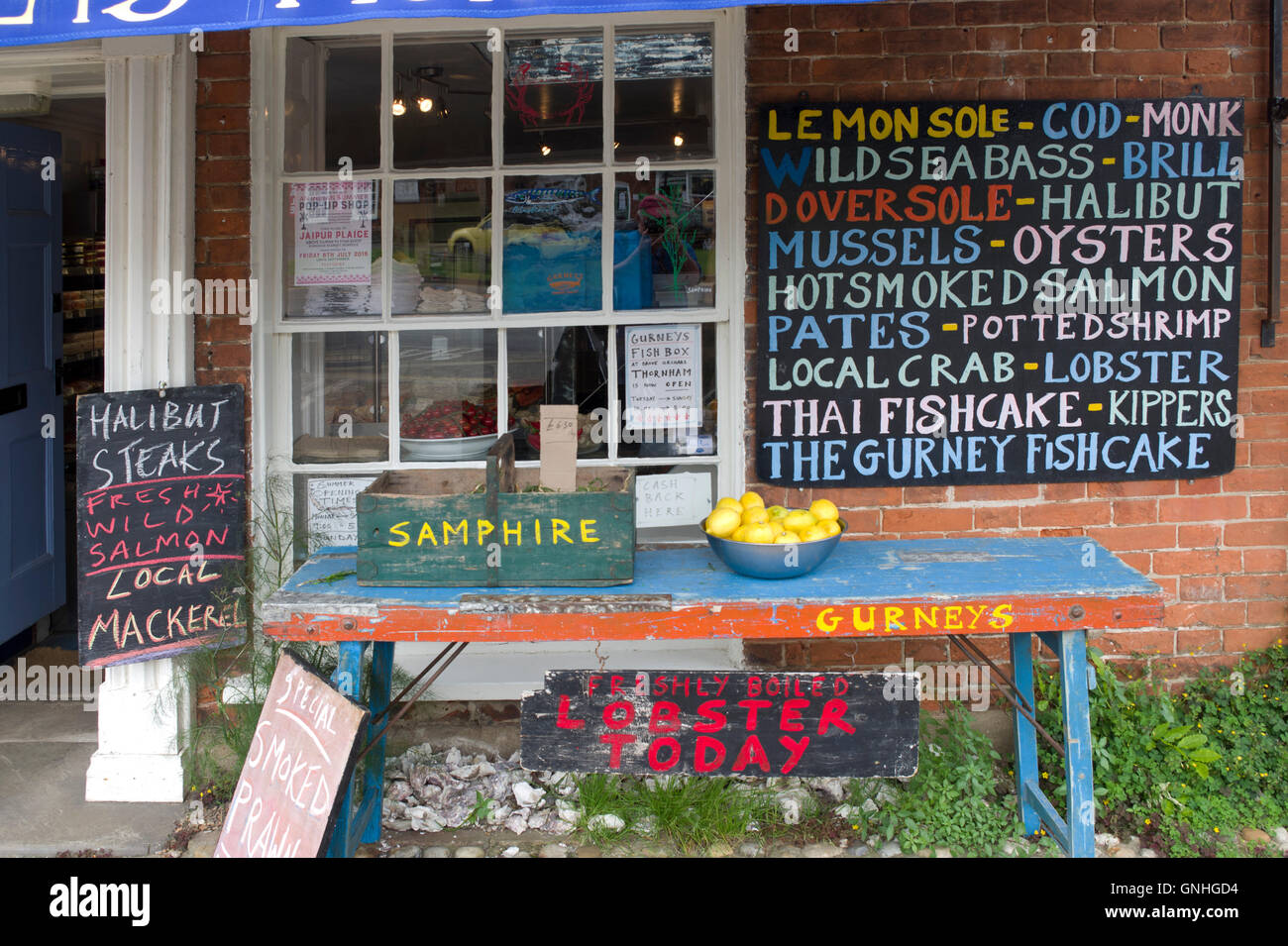 fish shop signs on front of Gurneys Fish shop in upmarket Norfolk village of Burnham Market Stock Photo