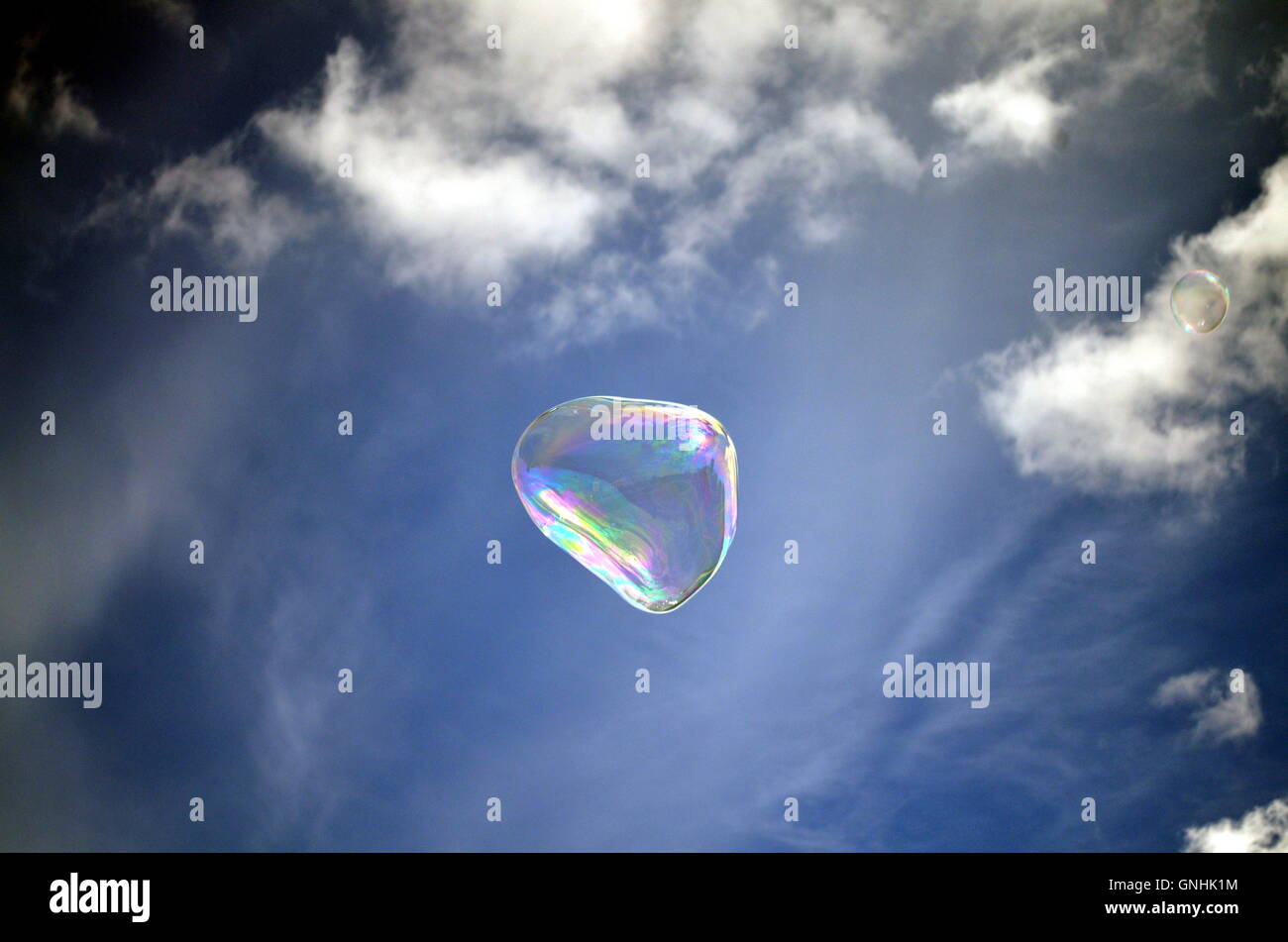 Soap rainbow bubble on blue sky background Stock Photo