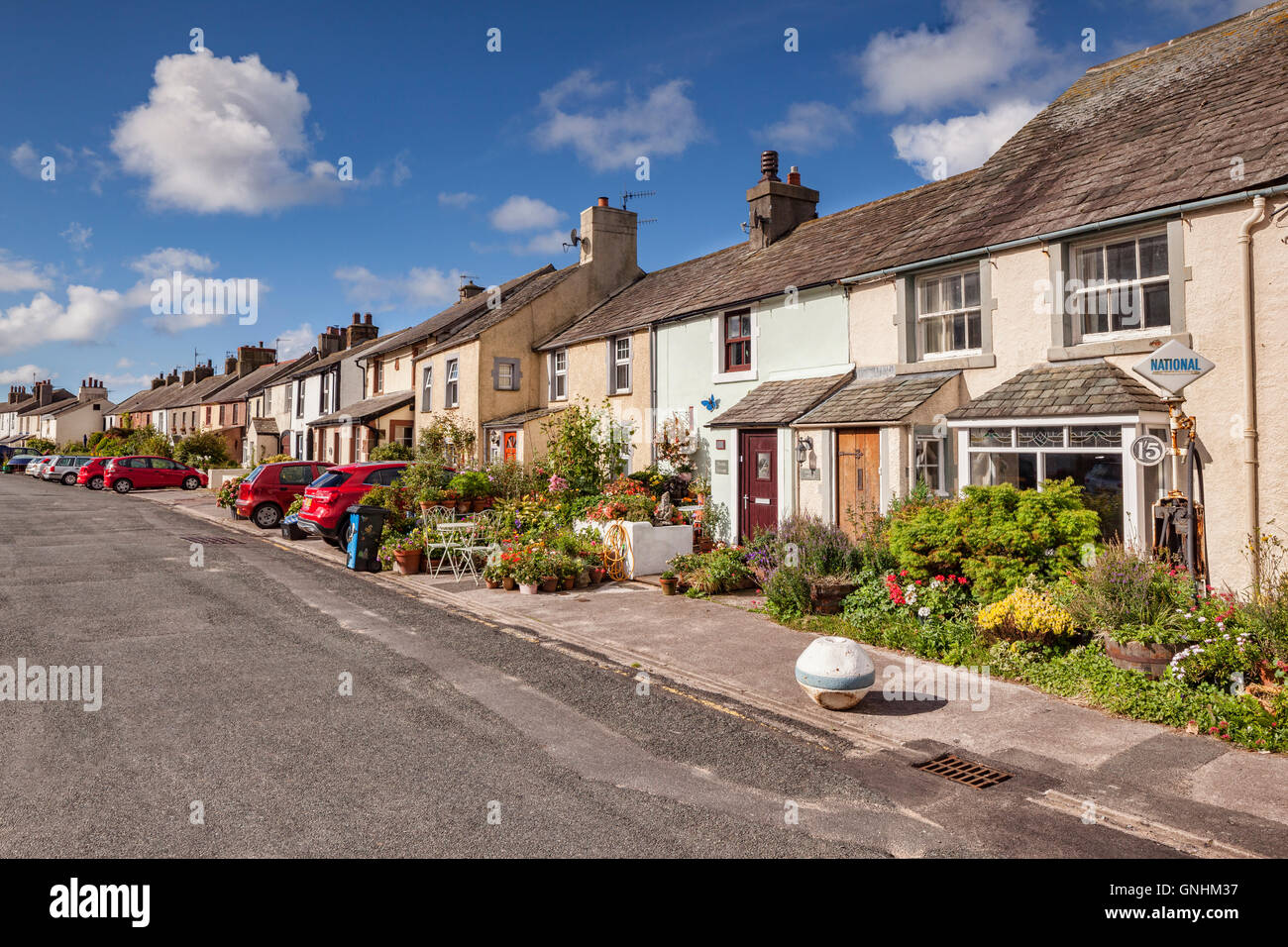 Row of cottages with lovely summer gardens in Main Street, Ravenglass, Cumbria, England, UK Stock Photo