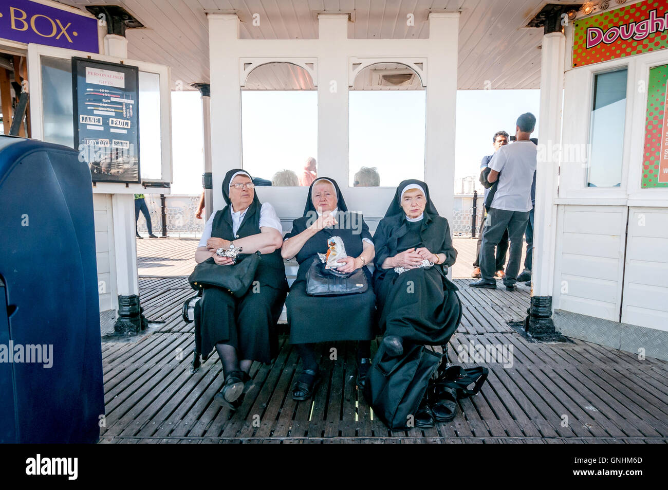 Three nuns on the pier at Brighton Stock Photo