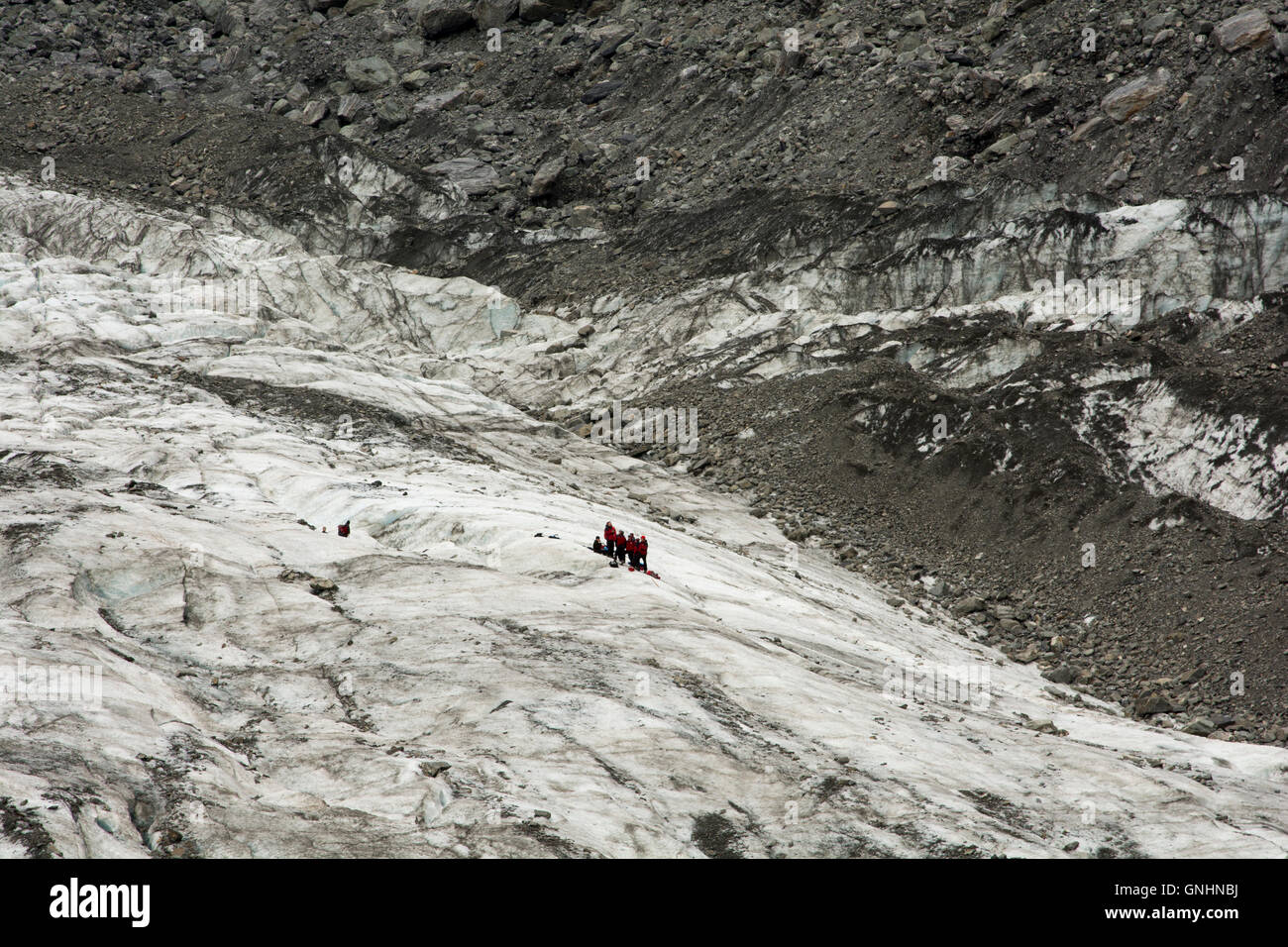 On top of Fox glacier in the Southern Alps of New Zealand tourist are guided in spectacular tours. Stock Photo