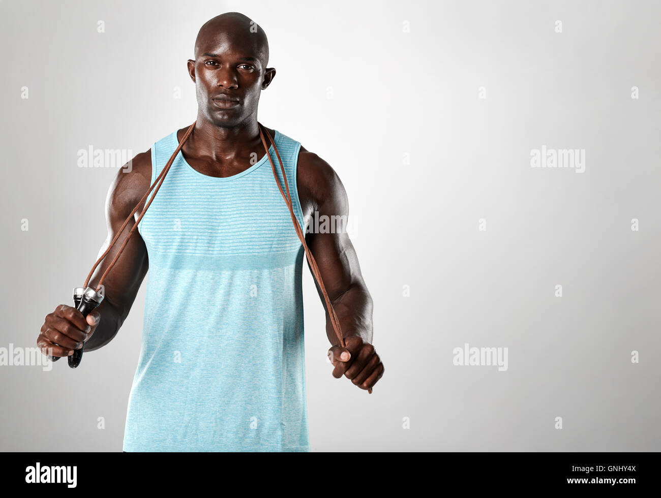 African Fitness Model With Skipping Rope Against Grey Background Handsome Muscular Man Posing