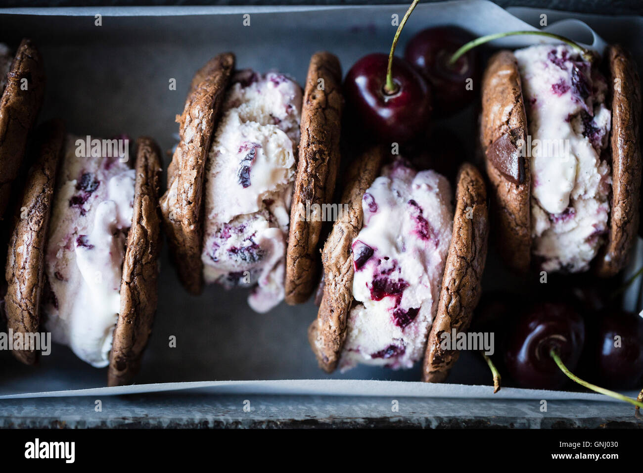 Roasted cherry ice cream sandwiches with salted double chocolate buckwheat cookies (gluten-free) Stock Photo