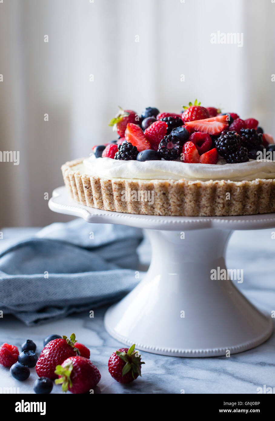 No-Bake Lemon Berry Coconut Cream Tart with fresh berries (vegan, gluten-free, refined sugar-free) Stock Photo