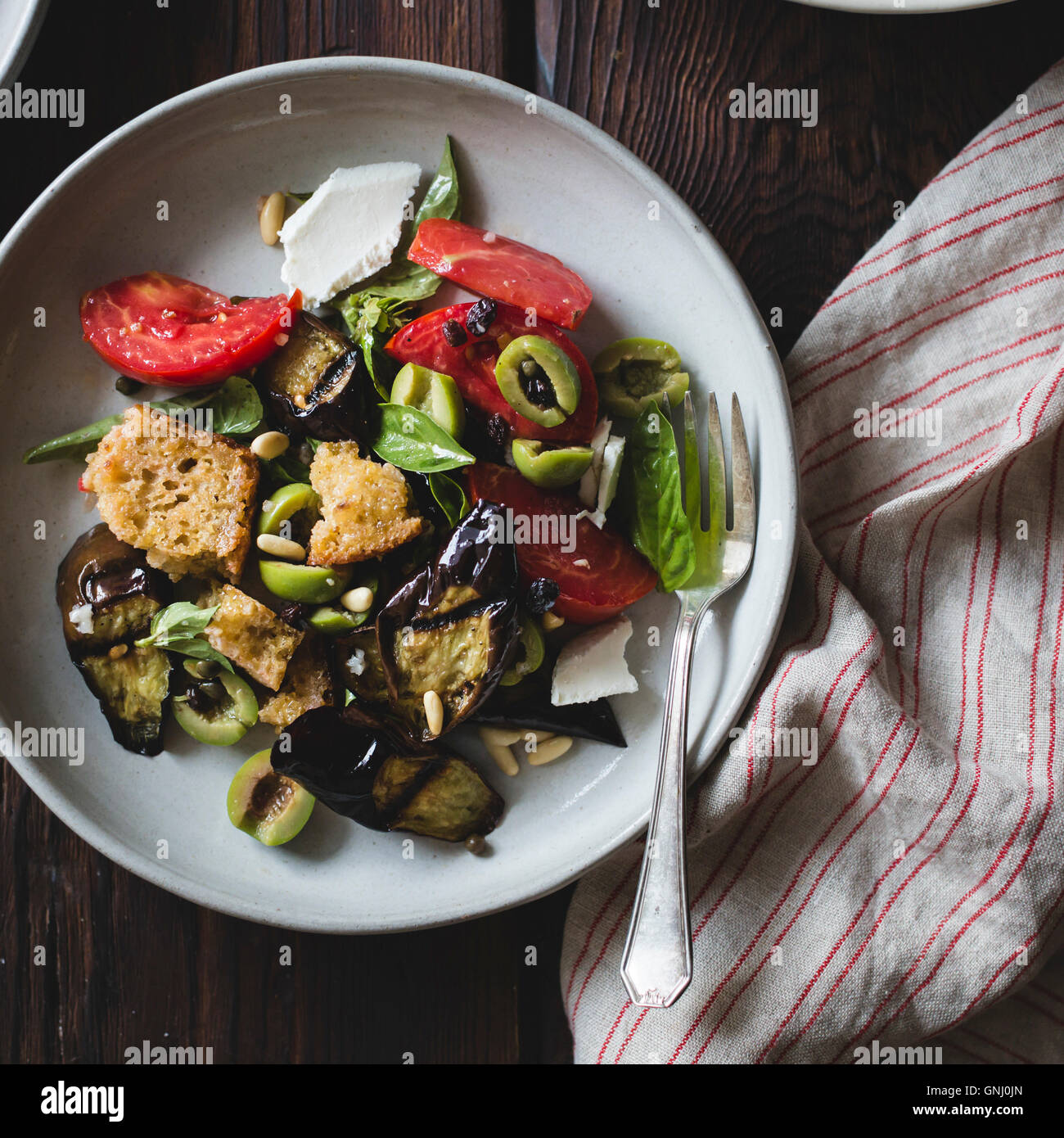 Roasted eggplant panzanella with capers, olives, and pine nuts, gluten