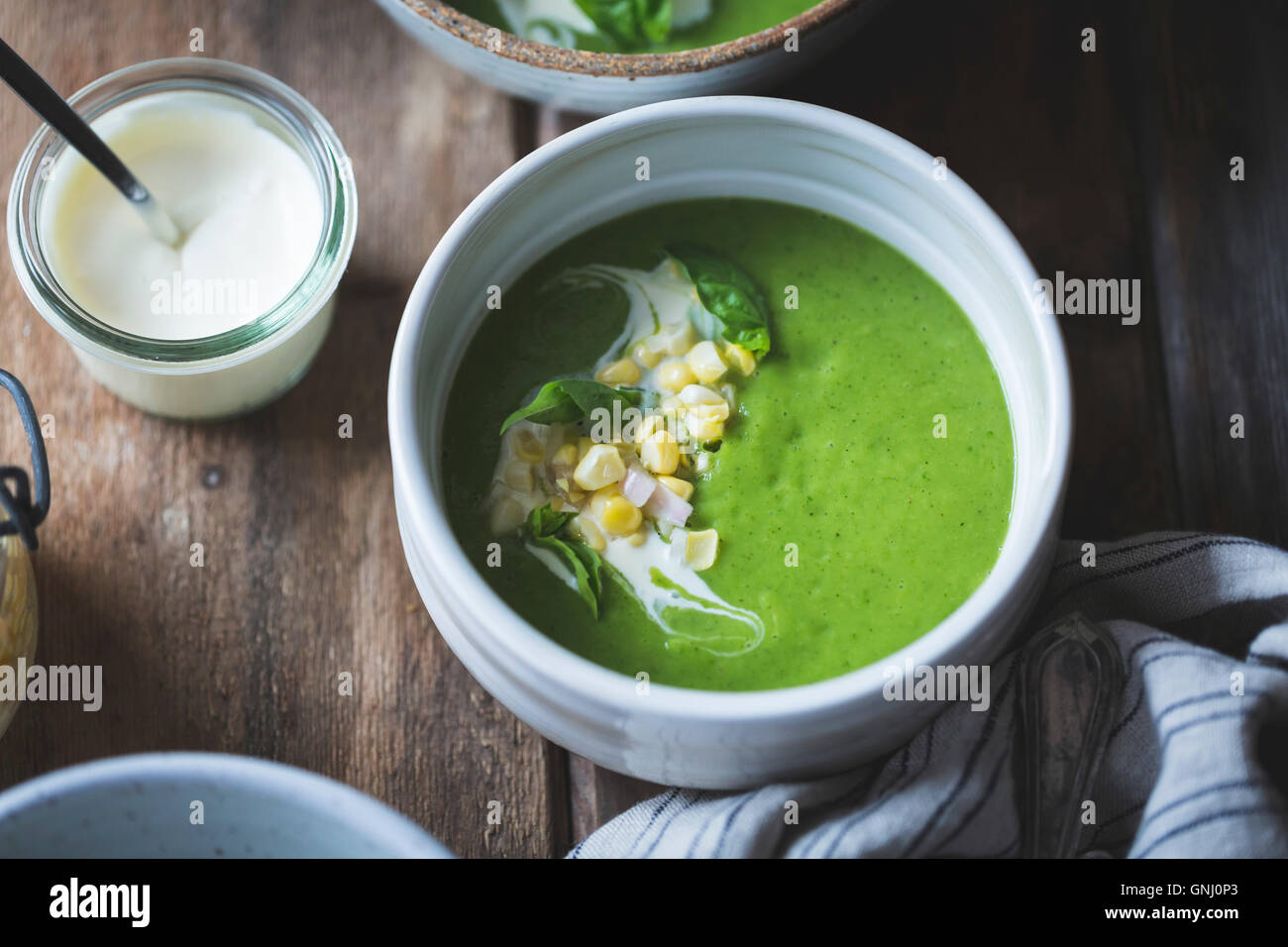 zucchini basil soup with crème fraîche and pickled corn Stock Photo