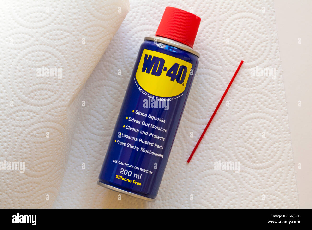 Can of WD40 with kitchen roll o wipe up any mess Stock Photo