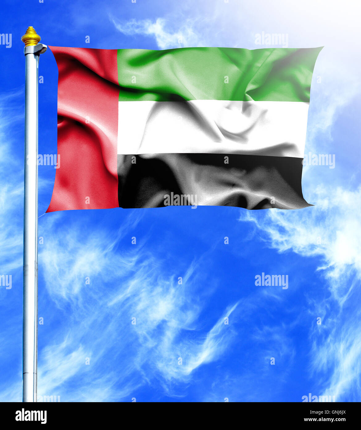Blue sky and mast with hanged waving flag of UAE Stock Photo