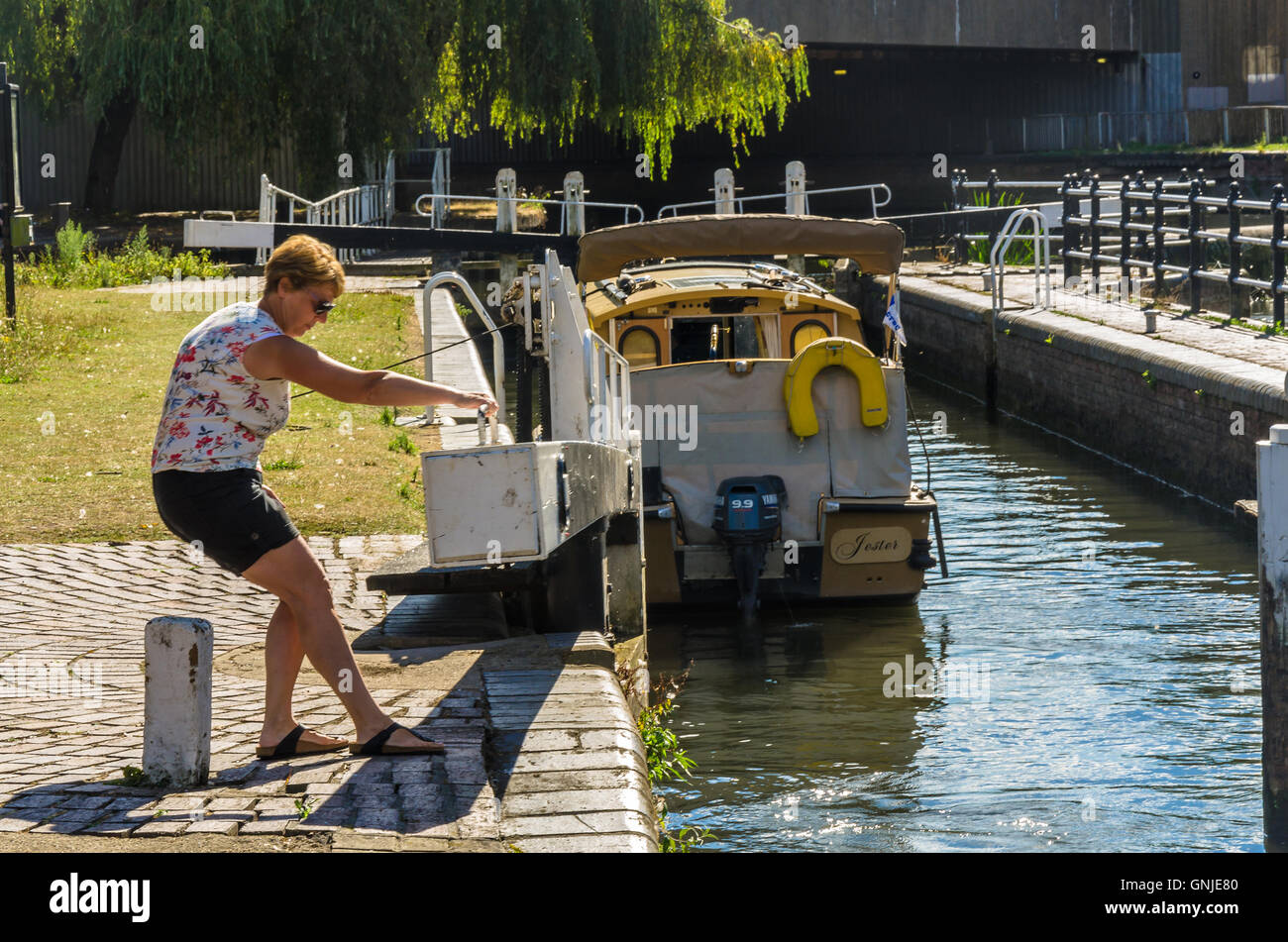 A lady closed a lock gate on the Kennet and Avon Canal. Stock Photo