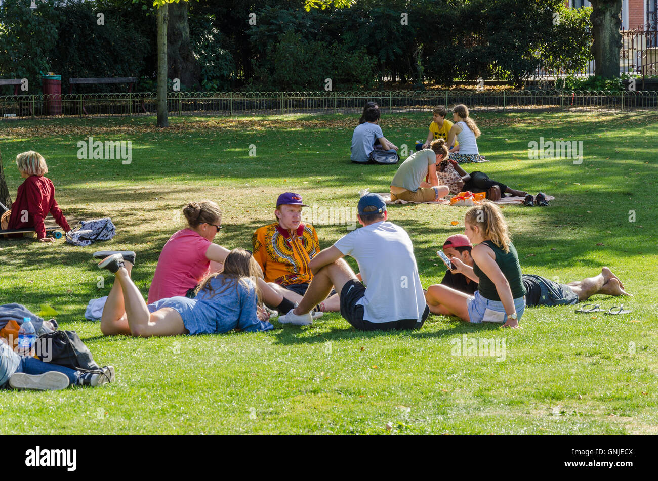 People relaxing and enjoying good weather on a summer's day in Forbury Gardens in Reading, Berkshire. Stock Photo