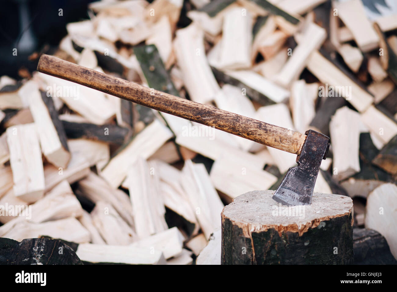 Axe stuck in a stump Stock Photo