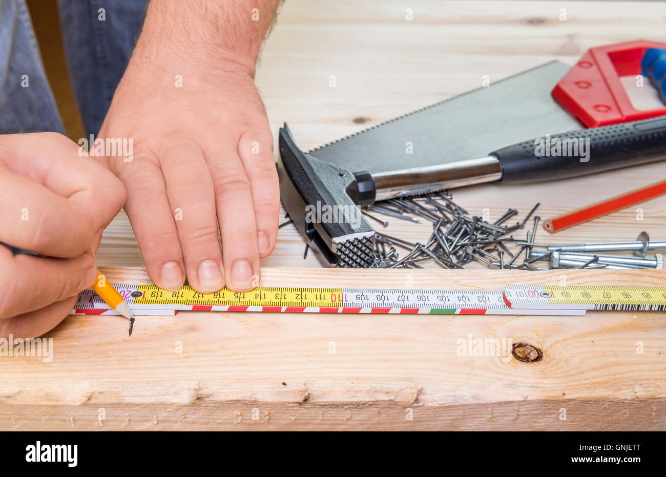 Woodworker hands and carpentry tools Stock Photo