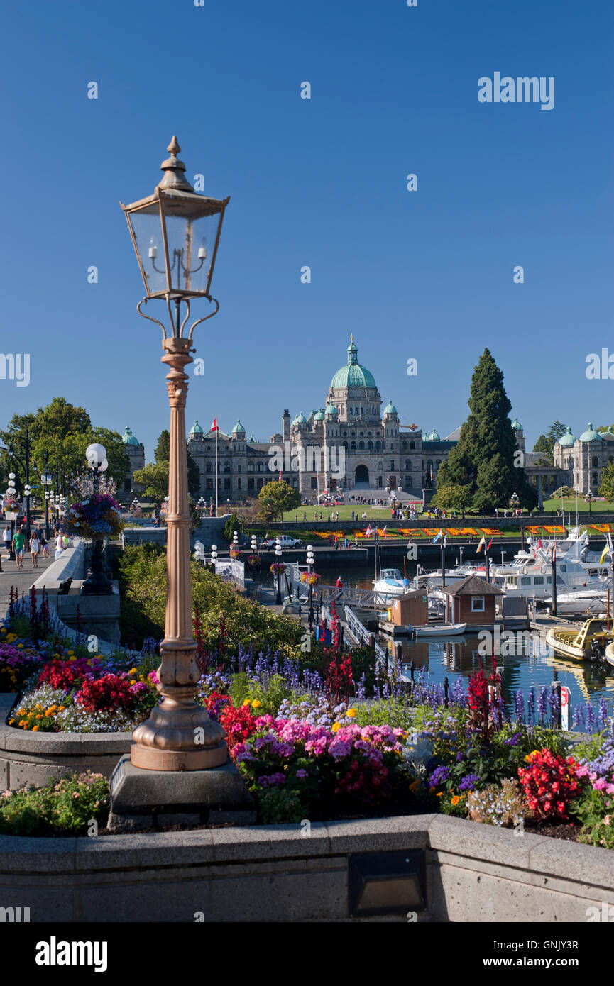 British Columbia Legislature building, Victoria, BC, Canada ornate lamppost and Flowers in foreground Stock Photo