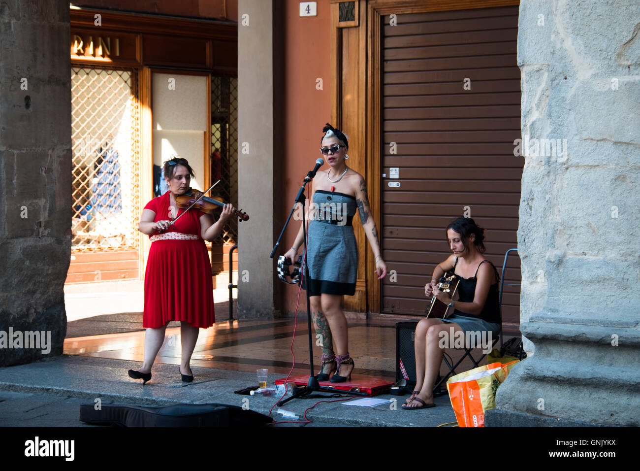 BOLOGNA, ITALY JULY 2016 Street musicians with a singer, violin and
