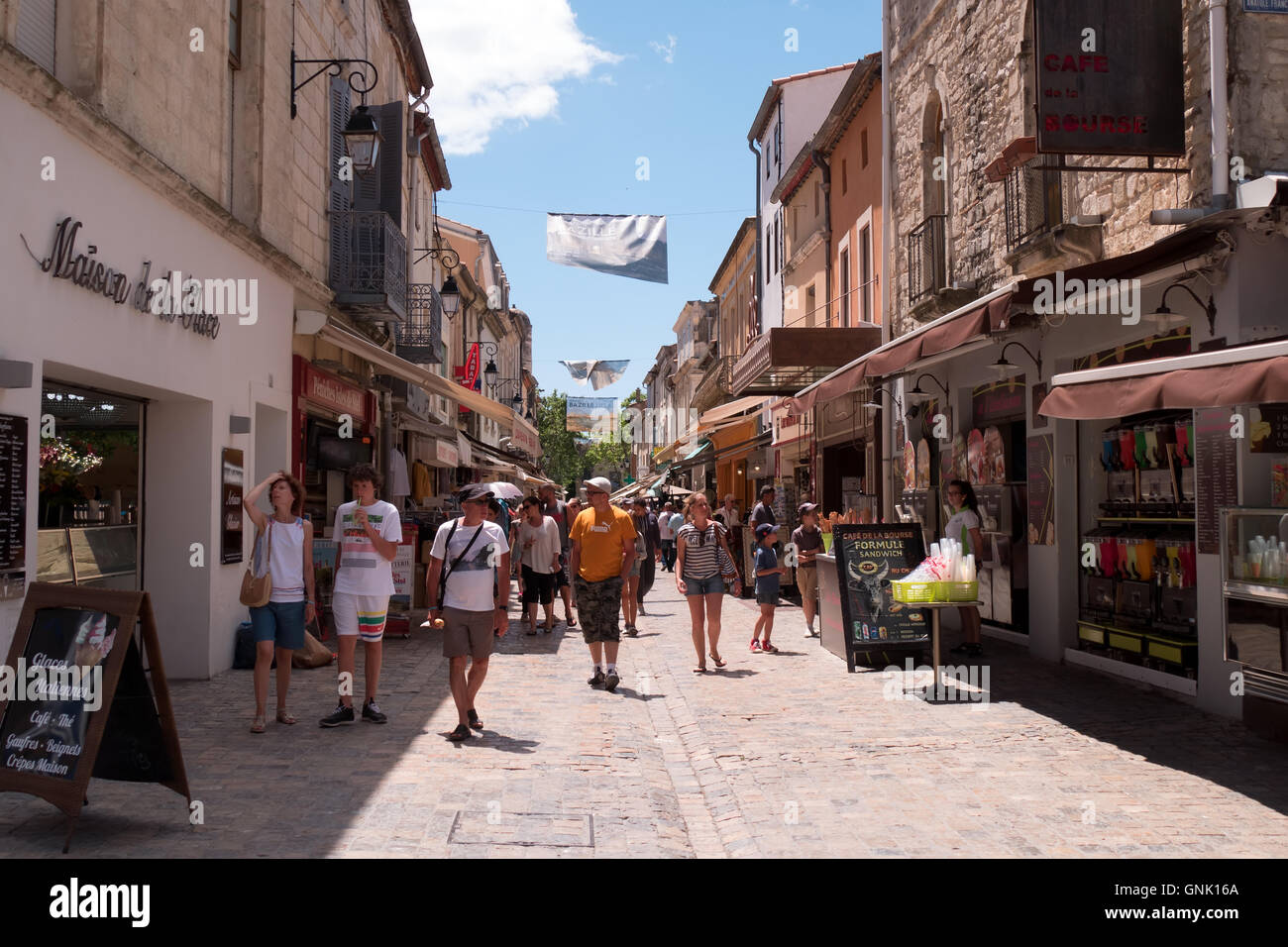 People and tourists shopping in the medieval village of Aigues-Mortes in Camargue, France. Aigues Mortes, old French town Stock Photo