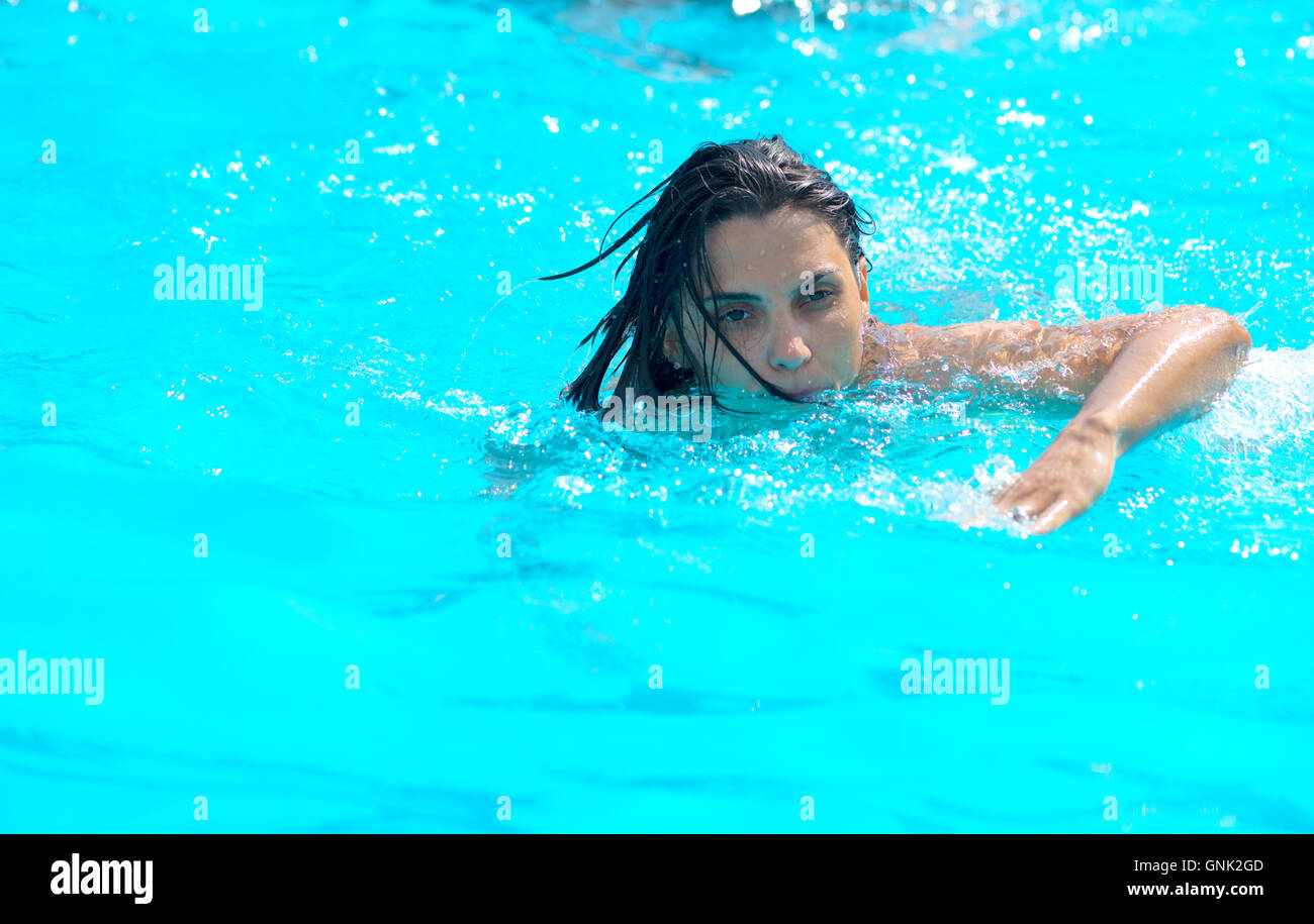 Young Woman Swimming Underwater In Pool Stock Photo