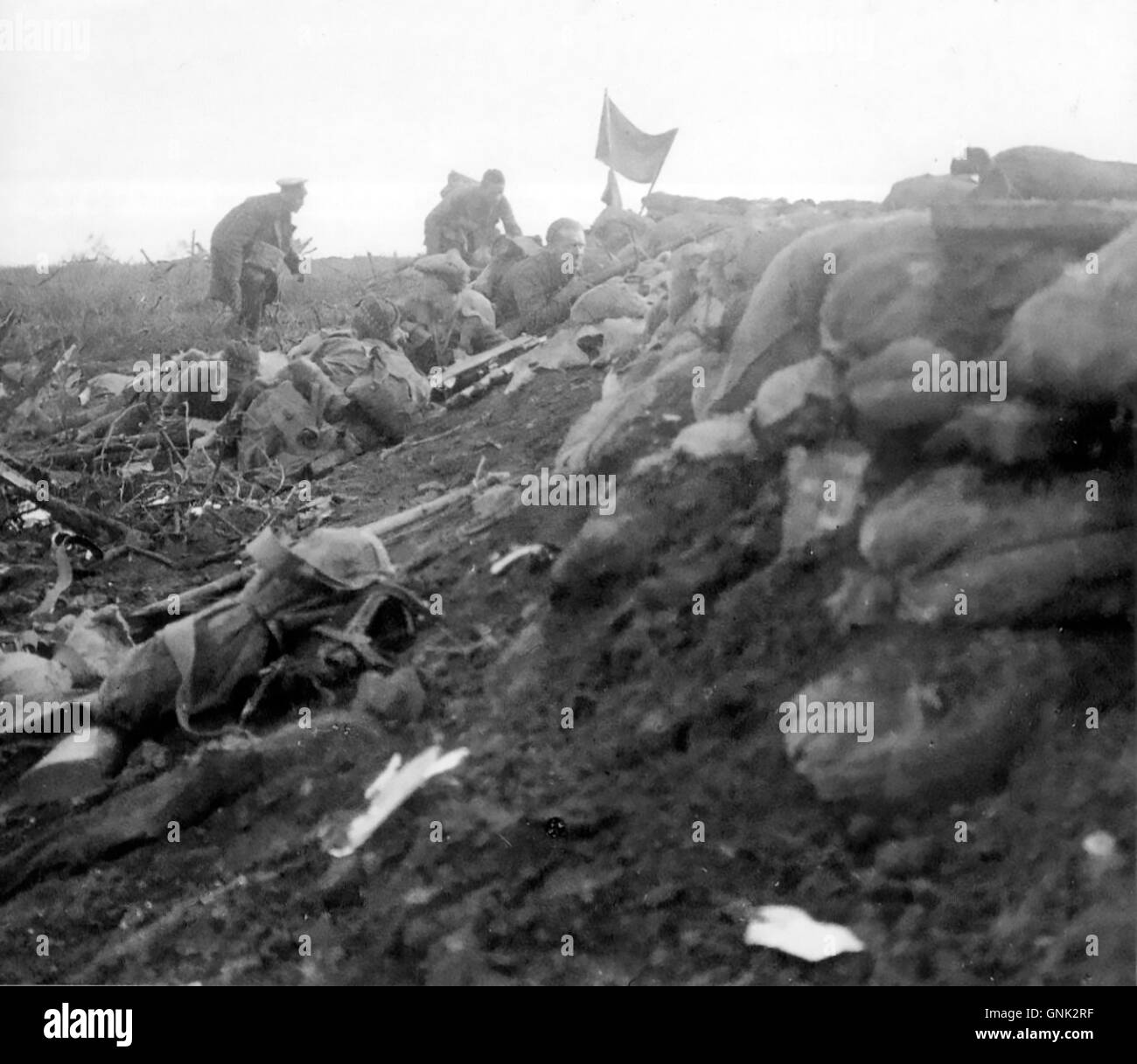 BATTLE OF HOOGE 16 June 1915. Liverpool Scottish soldiers have erected a flag as an artillery marker to show supporting guns that the area has been captured. The area was on the eastern side of the Ypres Salient in Flanders Stock Photo