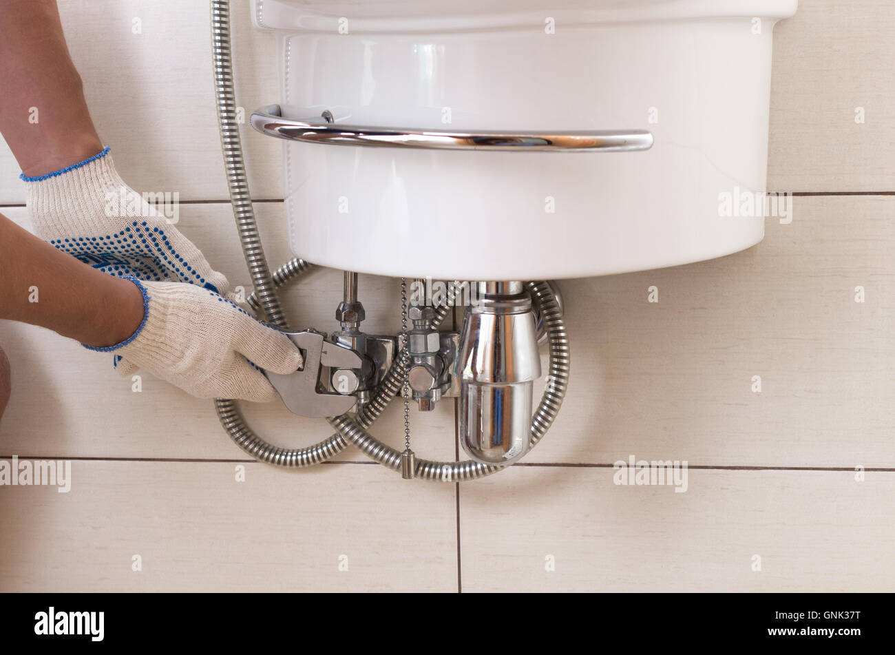 Closeup man fixing sink in a bathroom Stock Photo Alamy