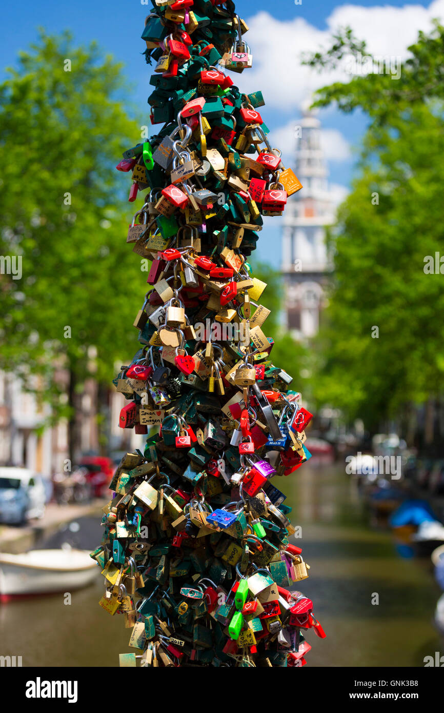 Lovers' padlocks left as romantic love token tradition on bridge at Groenburgwal in Old Town Amsterdam, Holland Stock Photo