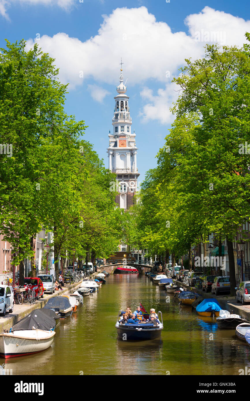Zuiderkerk in Old Town and tourist boat taking tour cruise group sightseeing on Dutch canals, Groenburgwal, Amsterdam, Holland Stock Photo