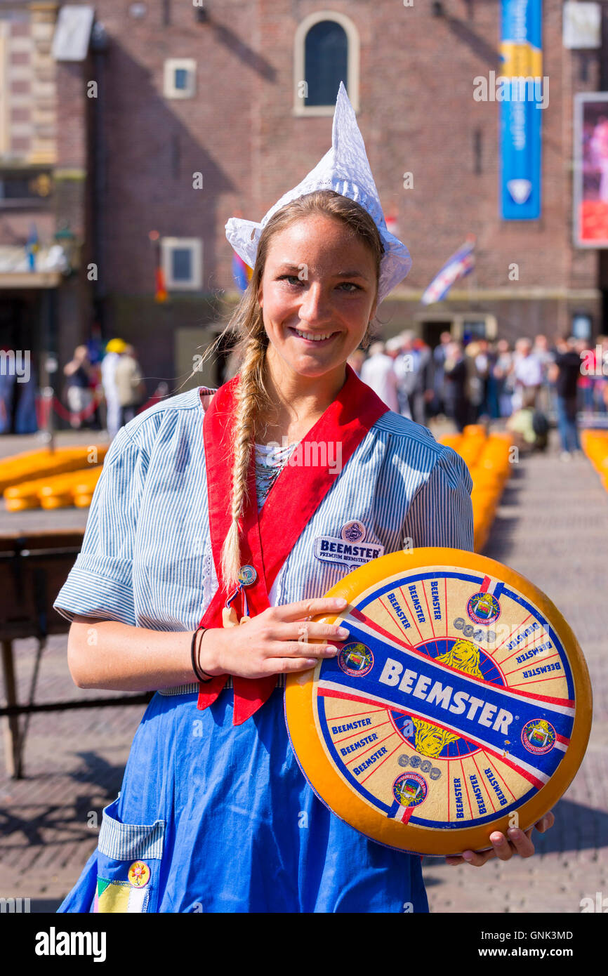 Dutch girl Kaasmeisje wearing traditional costume and Beemster Gouda