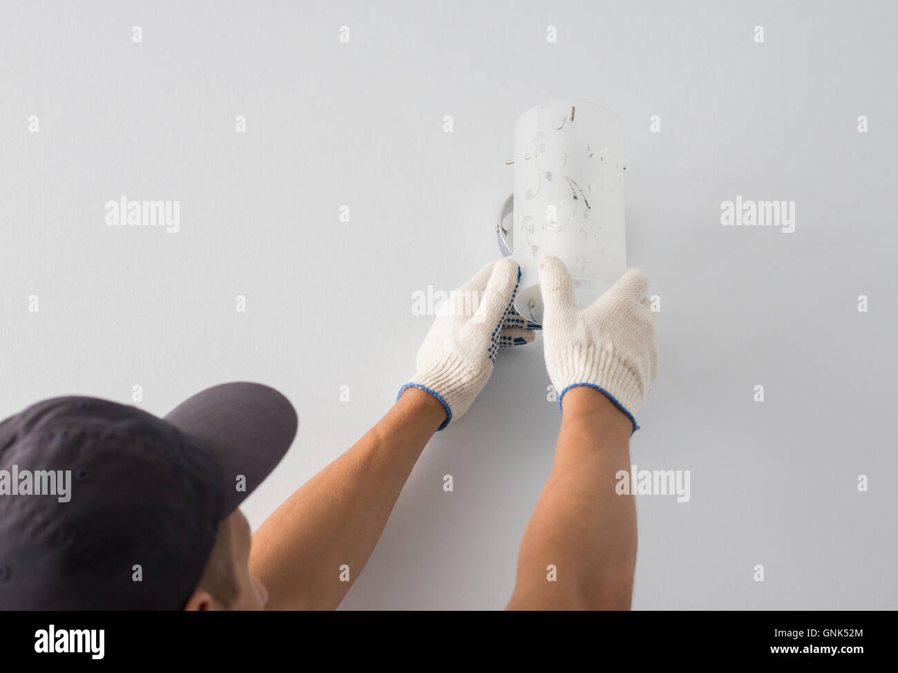 Man changes an electric light bulb, energy efficiency Stock Photo