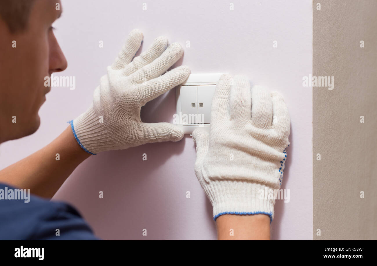 Electrician installing light switch, close up photo Stock Photo