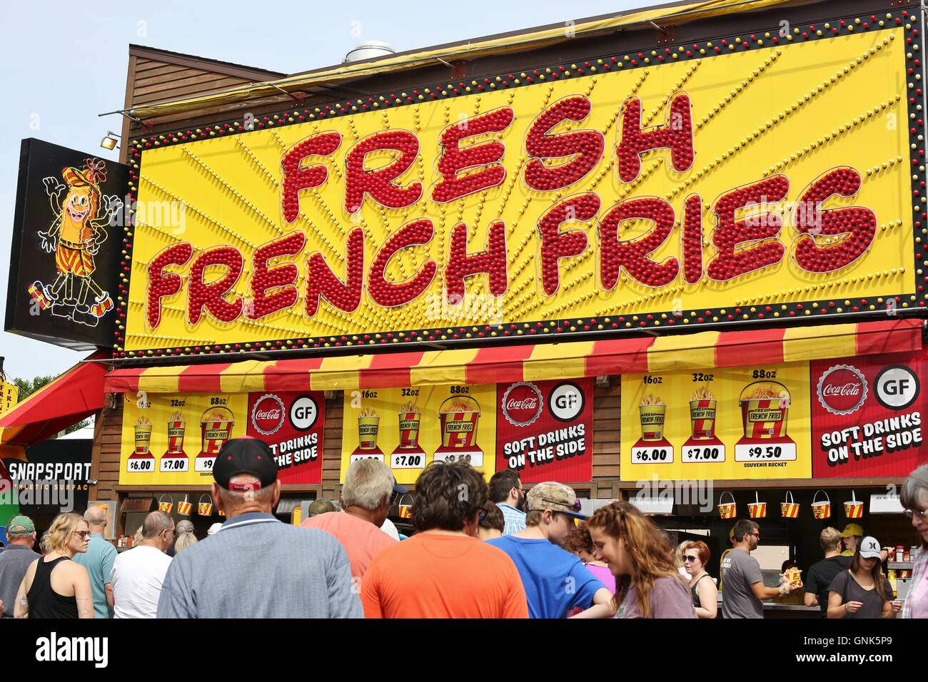 A crowd of people at a french fries stand at the Minnesota State Fair