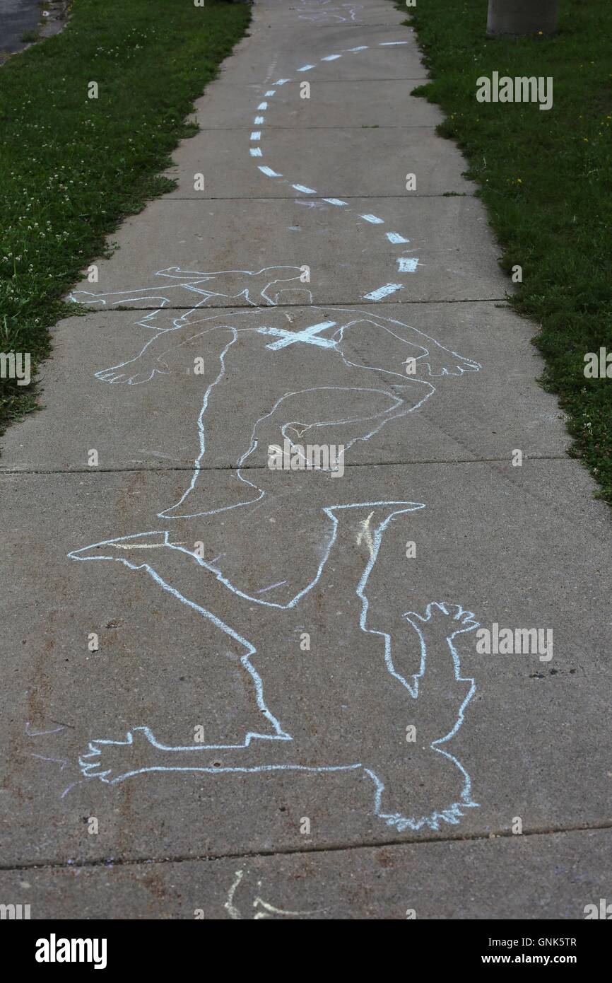 Chalk drawing depicting the outline of an adult and child's bodies. Stock Photo