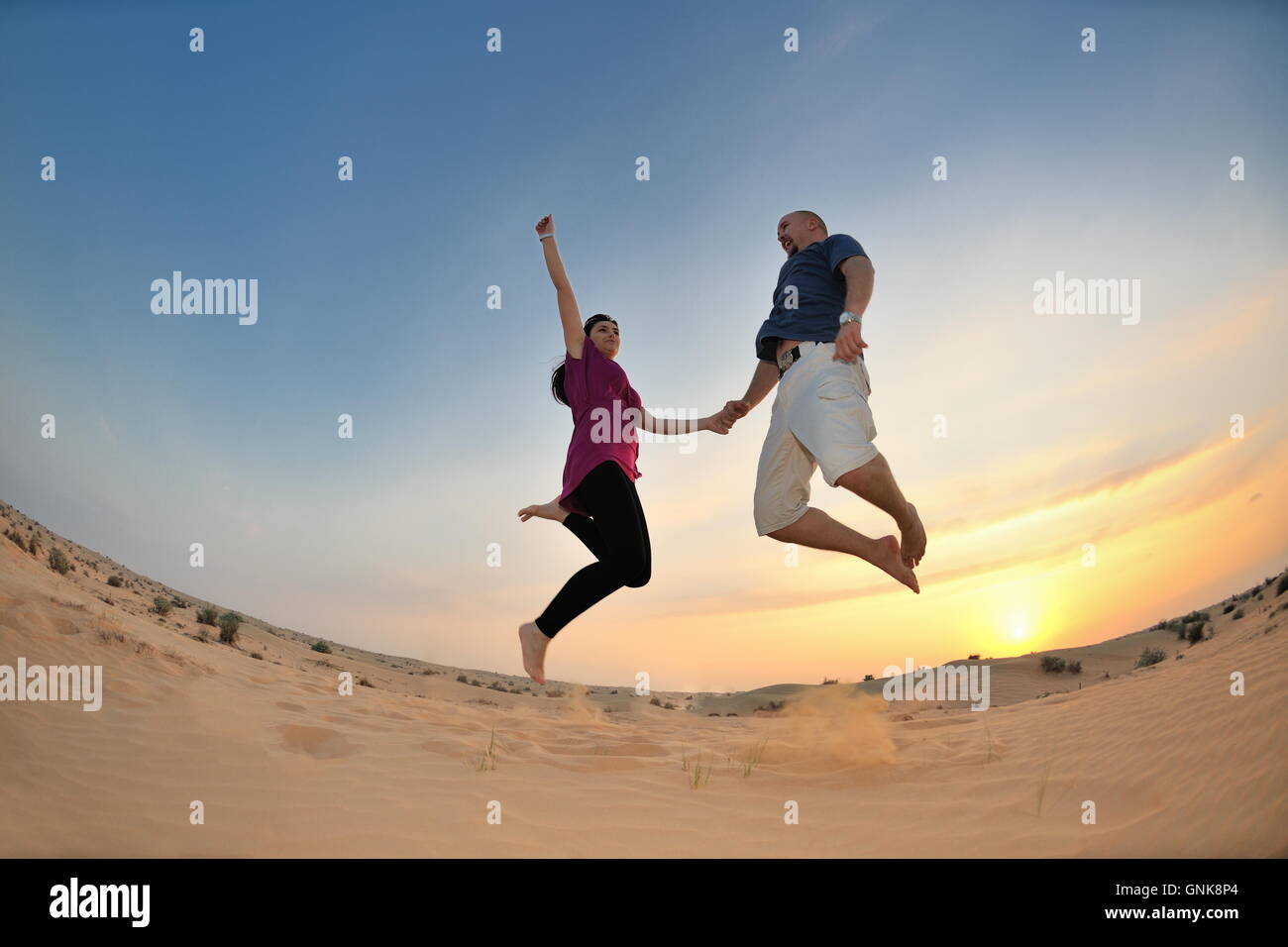 couple enjoying the sunset Stock Photo - Alamy