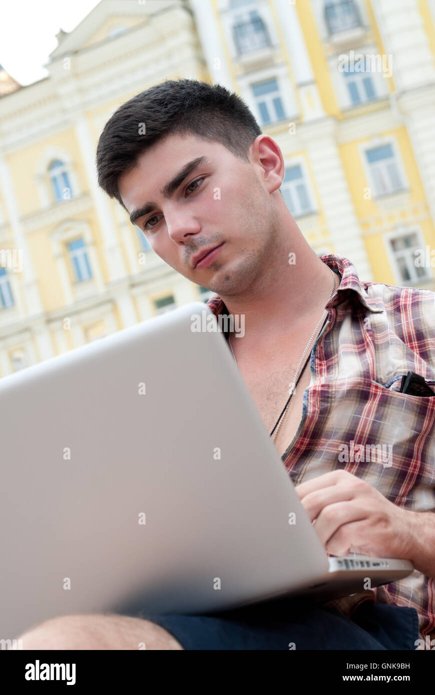 Young man with laptop Stock Photo - Alamy