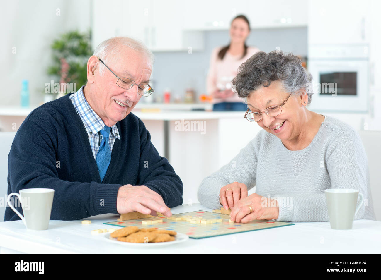 Grandparents playing a board game Stock Photo Alamy